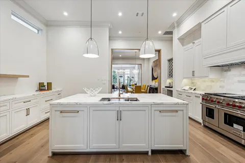 a kitchen with a sink stove and cabinets