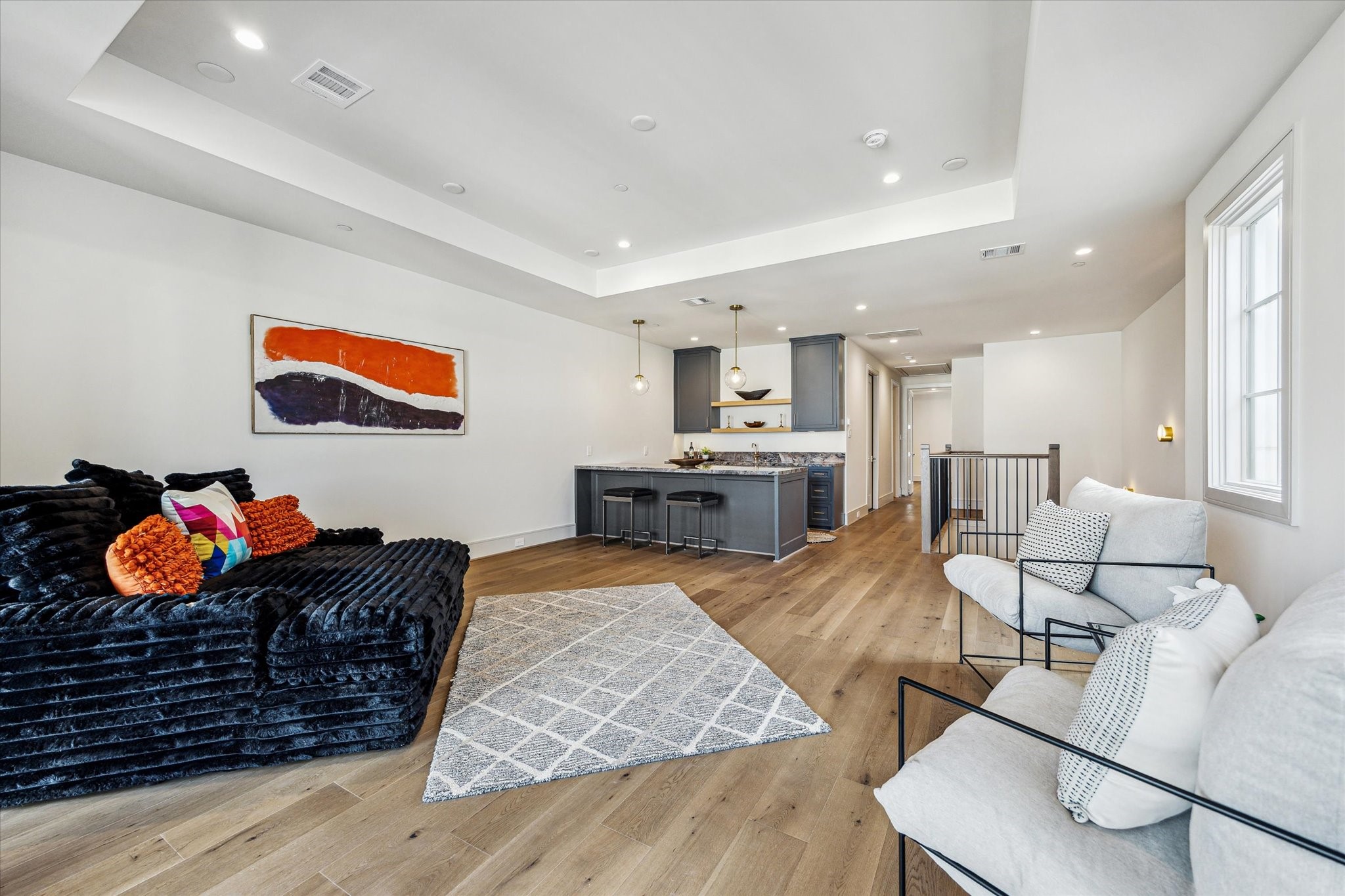 1215 West Pierce Street Houston, TX 77019 - Photo 33 of 40 The fourth floor boasts a generous City Room, perfect for entertaining or relaxing. The tray ceiling helps define the space and creates distinction between the room and the wet bar.