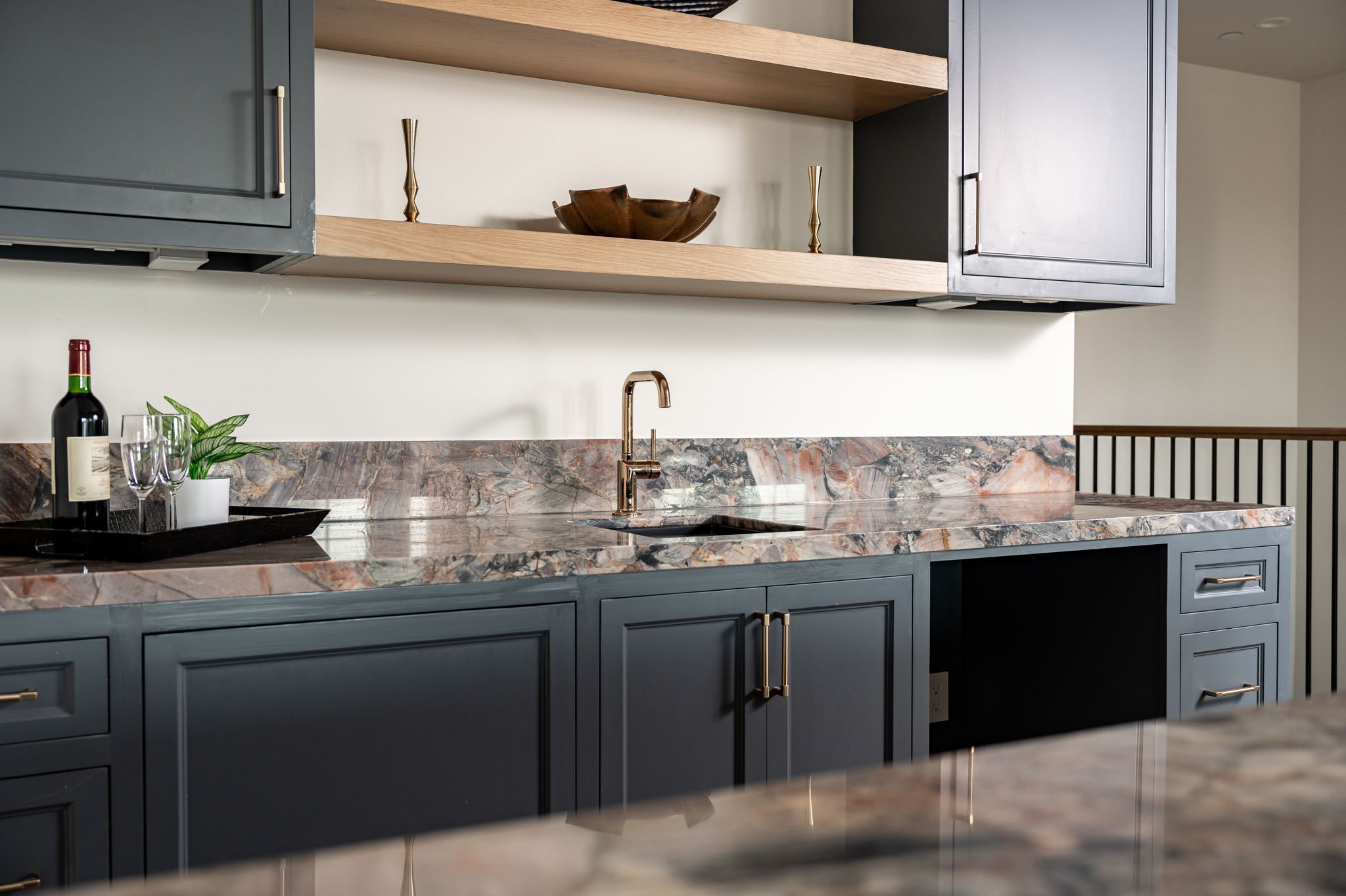 1215 West Pierce Street Houston, TX 77019 - Photo 35 of 40 The wet bar has a dynamic Marbella quartzite slab counter. The black quartz sink and Brizo Odin bar faucet will aid you in preparing snacks or cocktails. The opening will house a beverage cooler (to be installed).