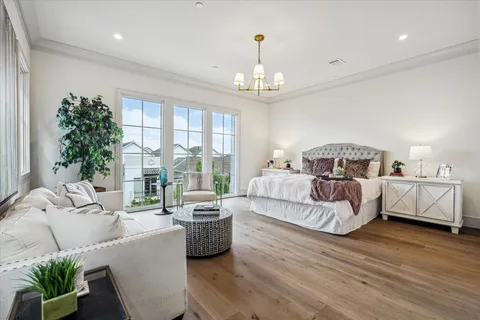 a bedroom with bed and a large window