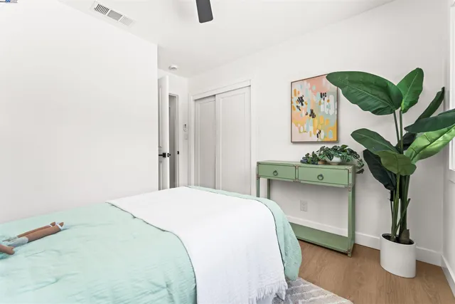 a bedroom with bed and a potted plant