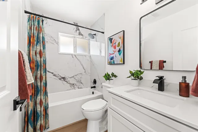 a bathroom with a sink a toilet and a bathtub