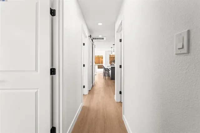 a view of a hallway with a wooden floors