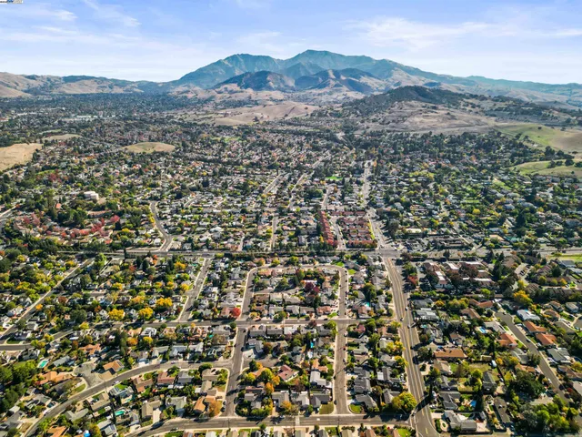 an aerial view of town with residential houses and mountain view