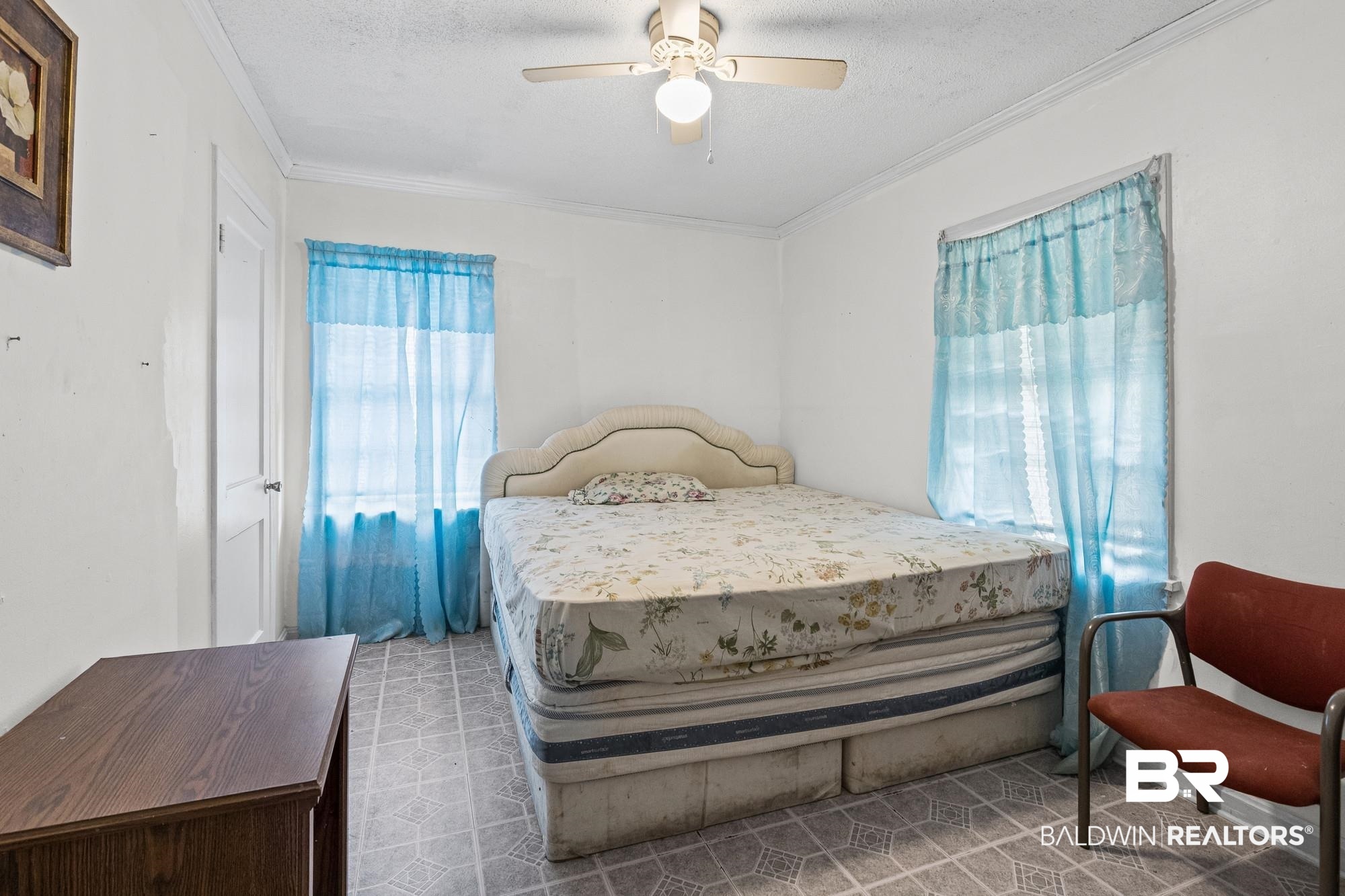 160 Glenn Avenue Mobile, AL 36606 - Photo 9 of 15 Room featuring patterned vinyl flooring, a white interior door, and two windows