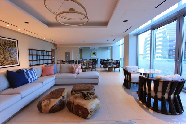 a living room with furniture kitchen view and a large window