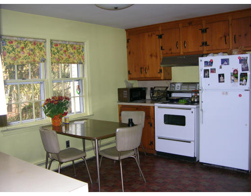 8 Pattee Road Harvard, MA 01451 - Photo 5 of 10 a kitchen with stainless steel appliances a stove a table and chairs