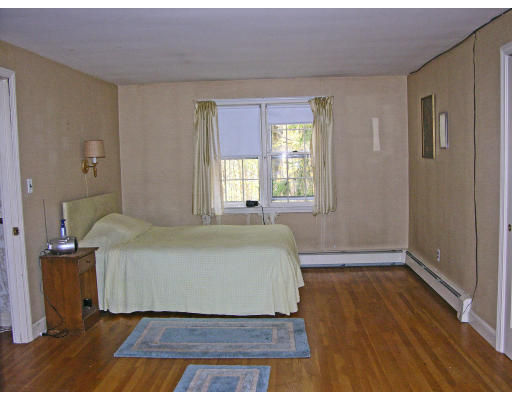8 Pattee Road Harvard, MA 01451 - Photo 7 of 10 a spacious bedroom with a bed and wooden floor
