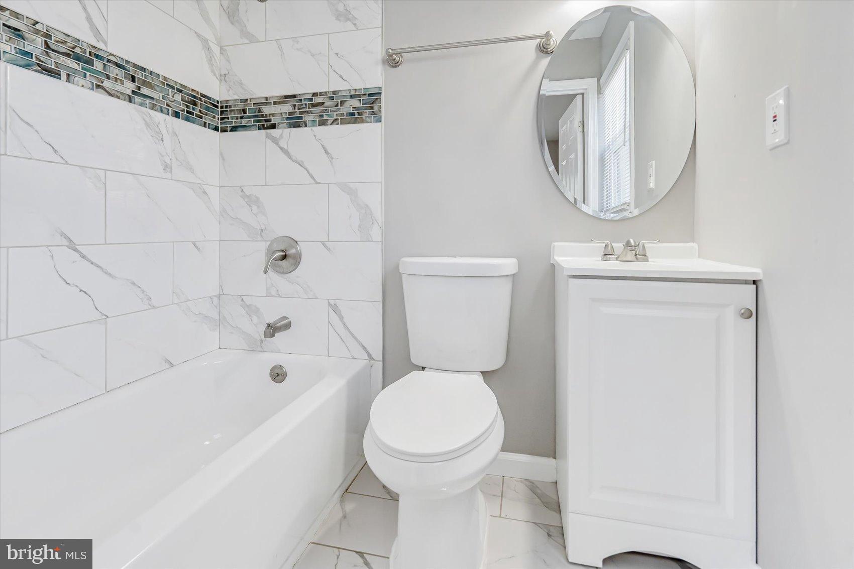 811 Rosedale Avenue Rosedale, MD 21237 - Photo 18 of 37 Modern bathroom with elegant tile accents.