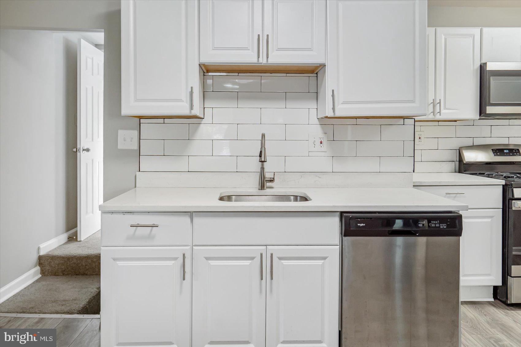 811 Rosedale Avenue Rosedale, MD 21237 - Photo 21 of 37 Modern kitchen with sleek white cabinetry.