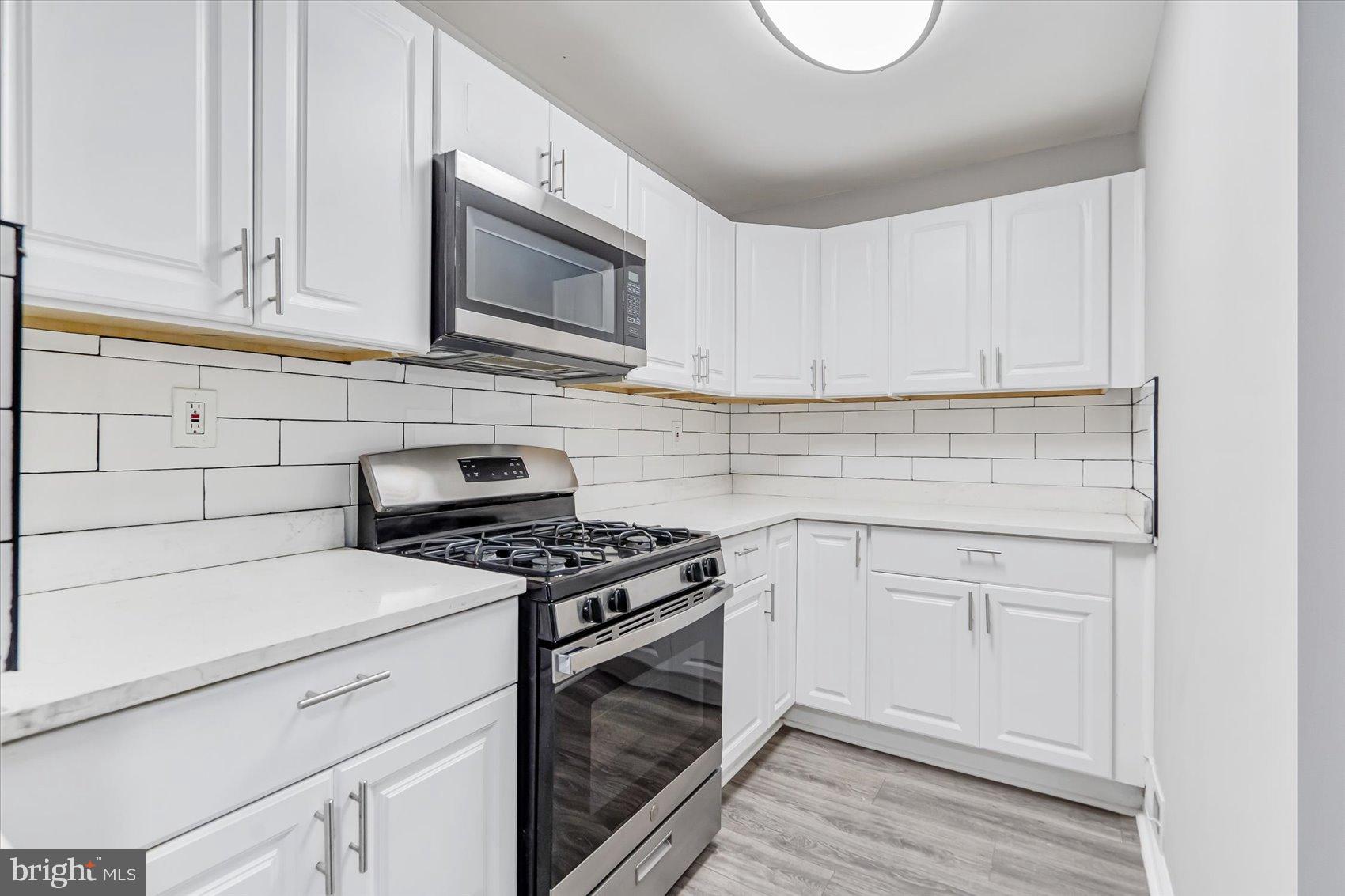 811 Rosedale Avenue Rosedale, MD 21237 - Photo 22 of 37 Modern kitchen with sleek white cabinetry.