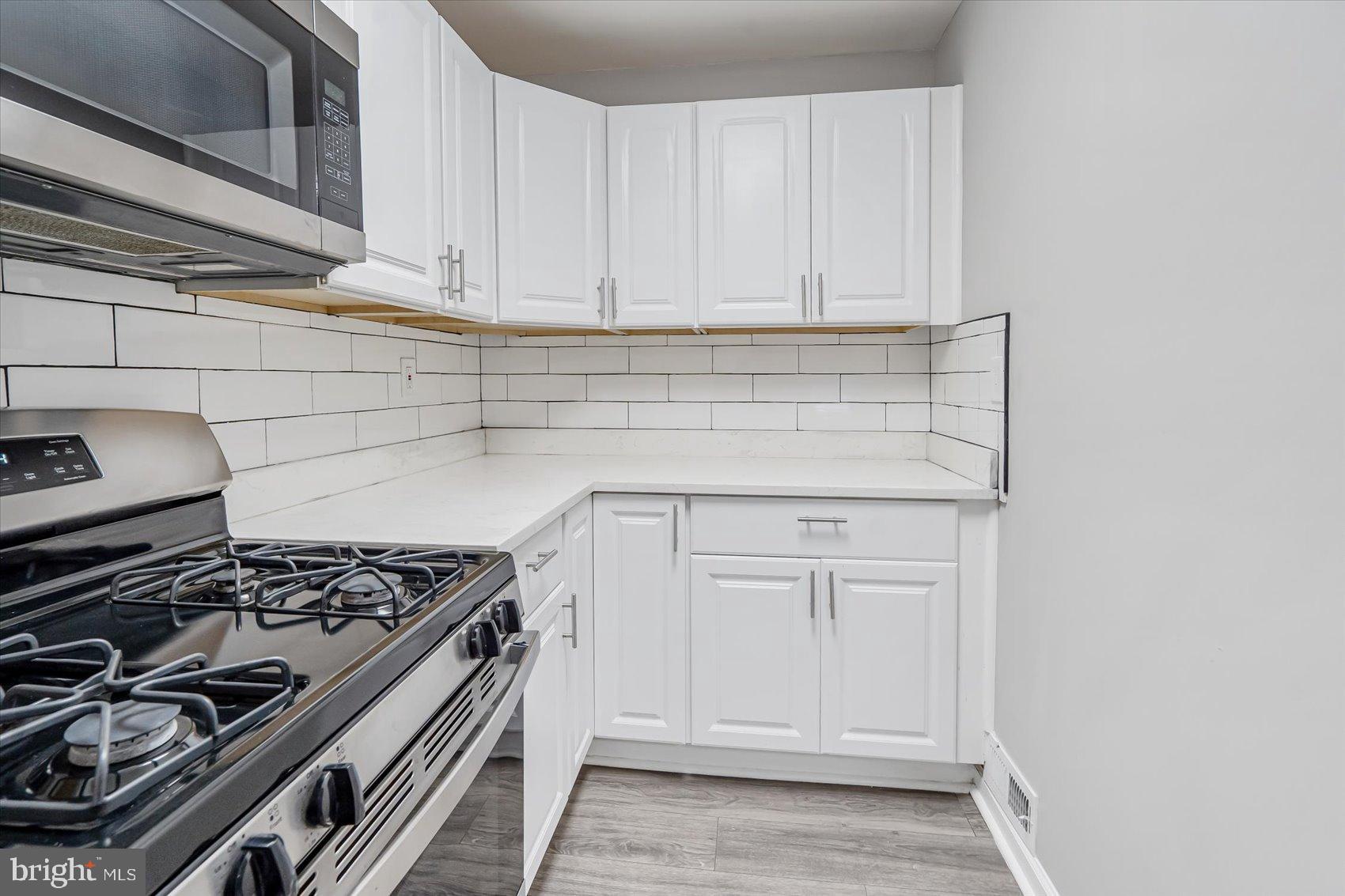 811 Rosedale Avenue Rosedale, MD 21237 - Photo 23 of 37 Modern kitchen with sleek white cabinetry.