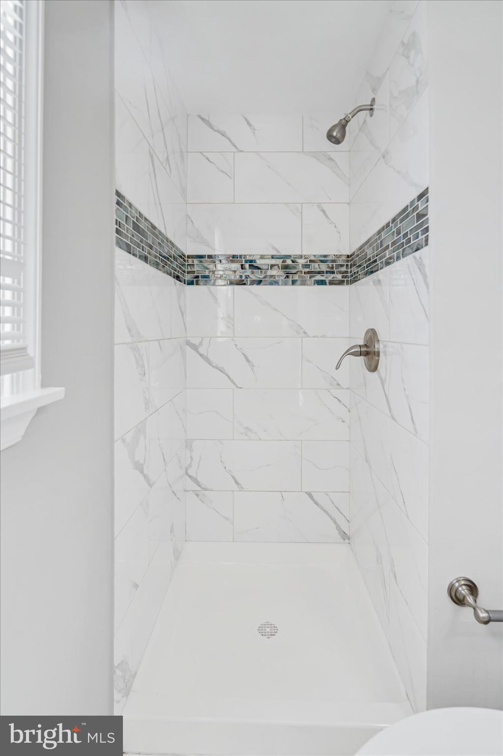 811 Rosedale Avenue Rosedale, MD 21237 - Photo 26 of 37 Elegant tiled shower with modern accents.