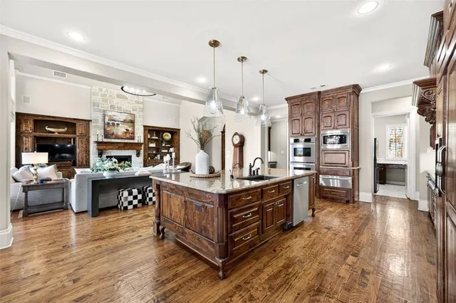 a kitchen with stainless steel appliances granite countertop a stove and a refrigerator