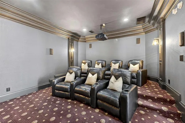 a media room with lots of chairs and a lamp