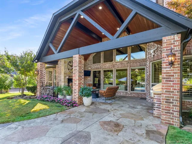a view of a porch with furniture and garden