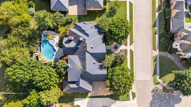 an aerial view of a house with a yard and garden