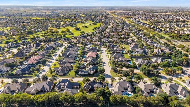 an aerial view of residential building with green space