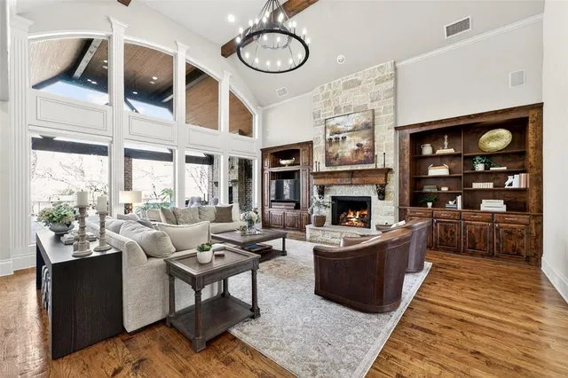 a living room with furniture a fireplace and a large window