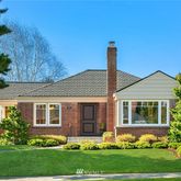 a front view of a house with a garden and plants