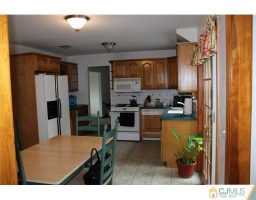 107 Oxford Road Colonia, NJ 07067 - Photo 3 of 13 a kitchen with stainless steel appliances kitchen island granite countertop a refrigerator and a sink