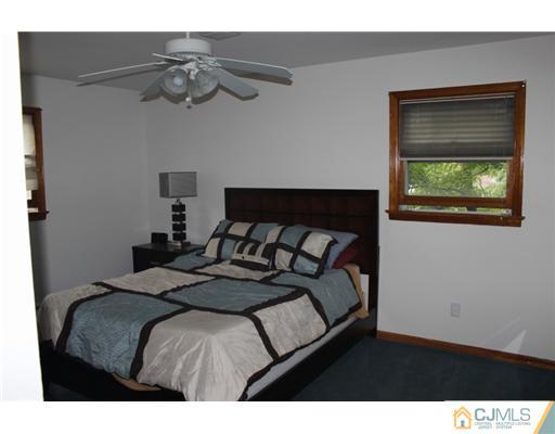107 Oxford Road Colonia, NJ 07067 - Photo 8 of 13 a bedroom with a bed and a chandelier