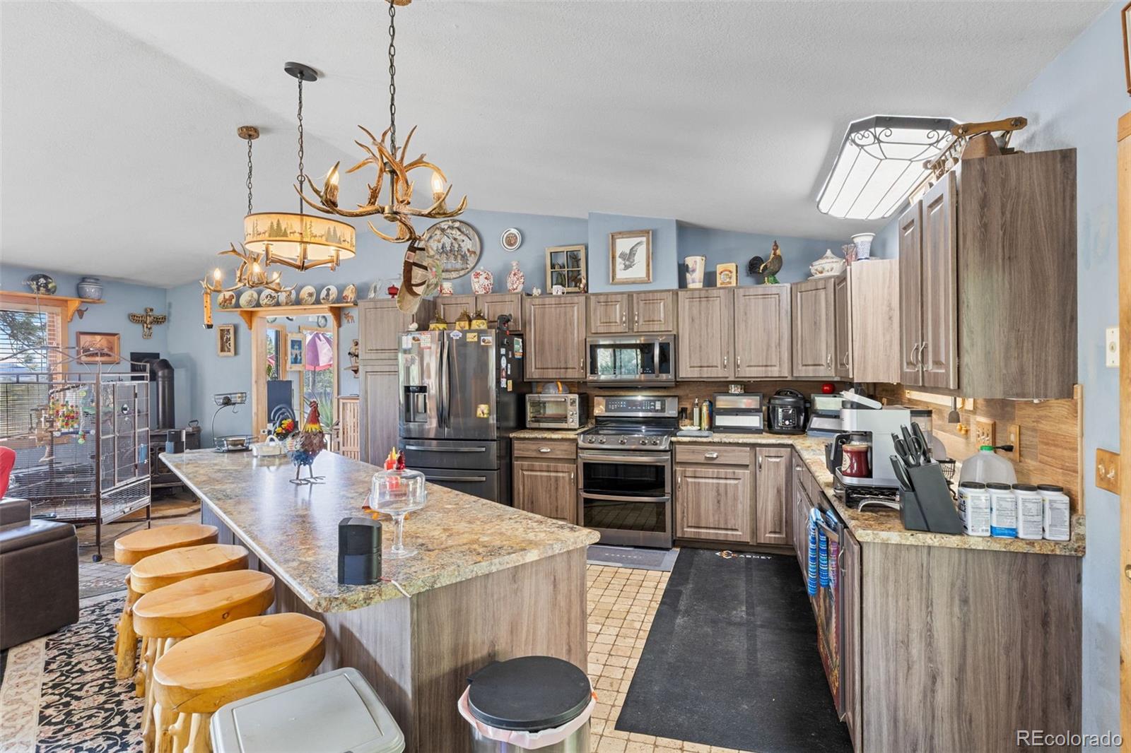 80 Fawn Road Bailey, CO 80421 - Photo 15 of 44 a very nice looking kitchen with granite countertop a sink a stove and chairs