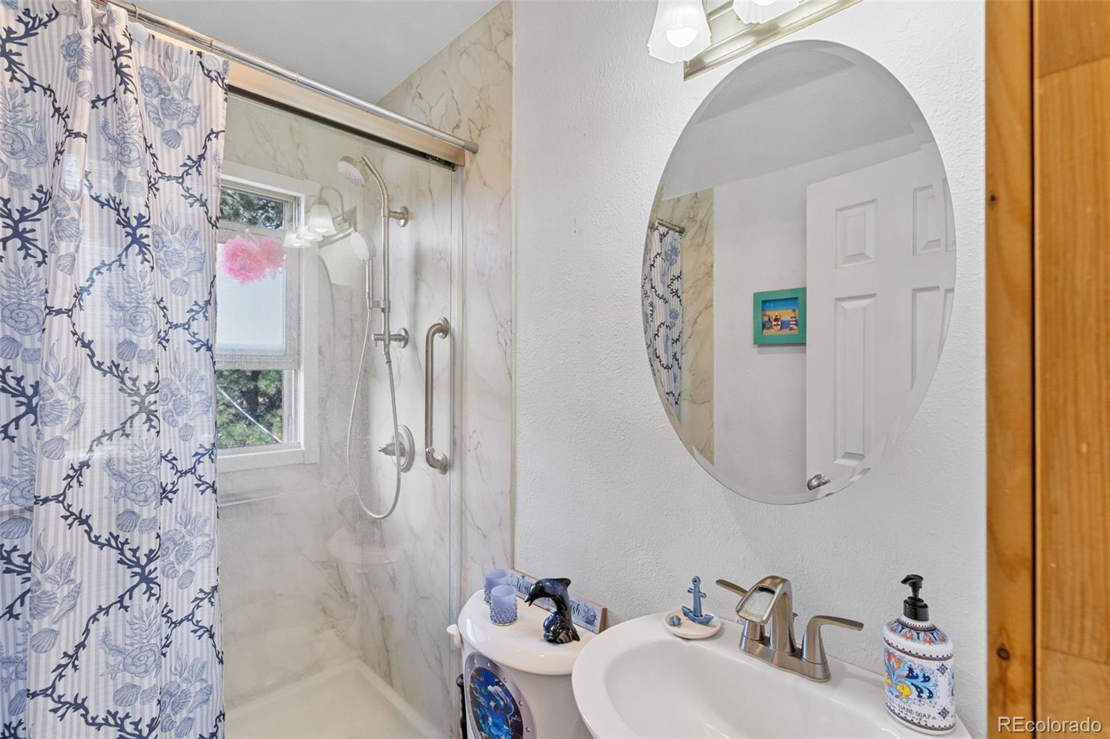 80 Fawn Road Bailey, CO 80421 - Photo 24 of 44 a bathroom with a sink mirror and shower