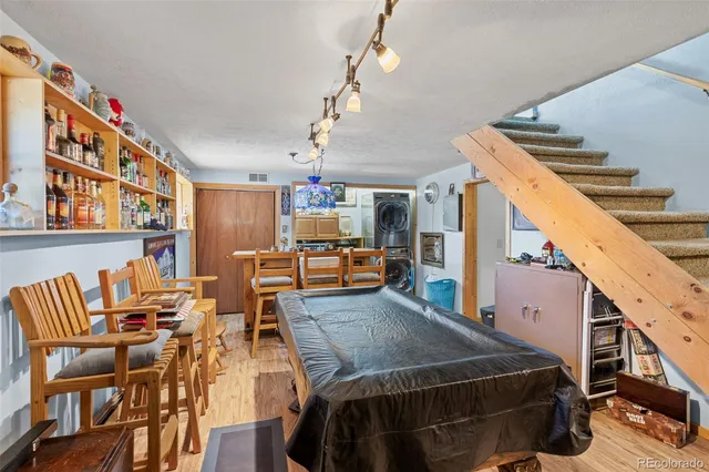 a living room with stainless steel appliances kitchen island granite countertop a refrigerator and a stove