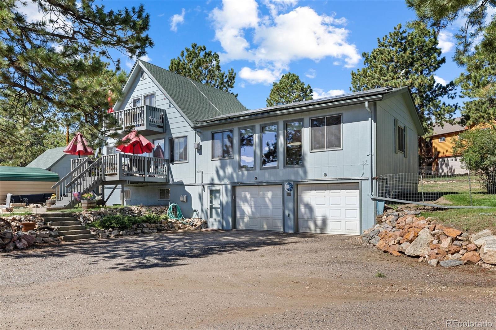 80 Fawn Road Bailey, CO 80421 - Photo 3 of 44 a front view of a house with a garage