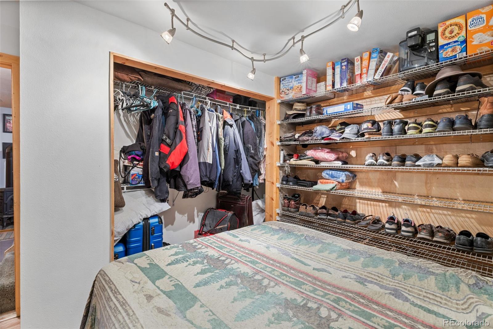 80 Fawn Road Bailey, CO 80421 - Photo 32 of 44 a view of walk in closet with clothes and shoes