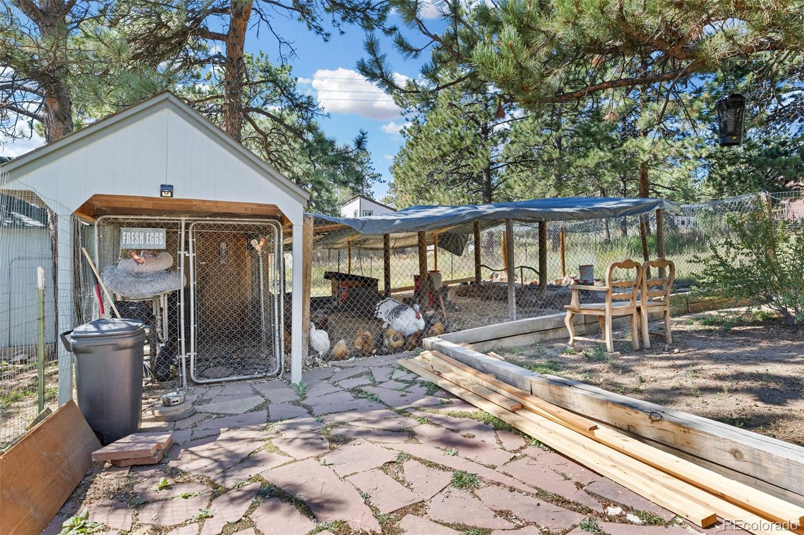 80 Fawn Road Bailey, CO 80421 - Photo 35 of 44 a view of a patio with a dining table and chairs with wooden fence