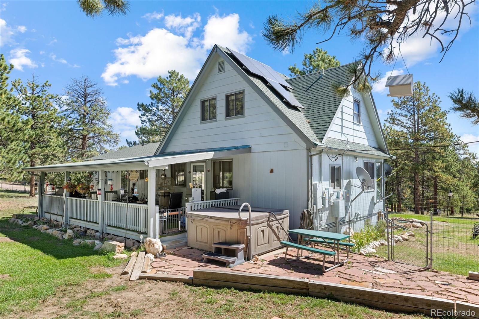 80 Fawn Road Bailey, CO 80421 - Photo 4 of 44 a view of a house with backyard porch and sitting area