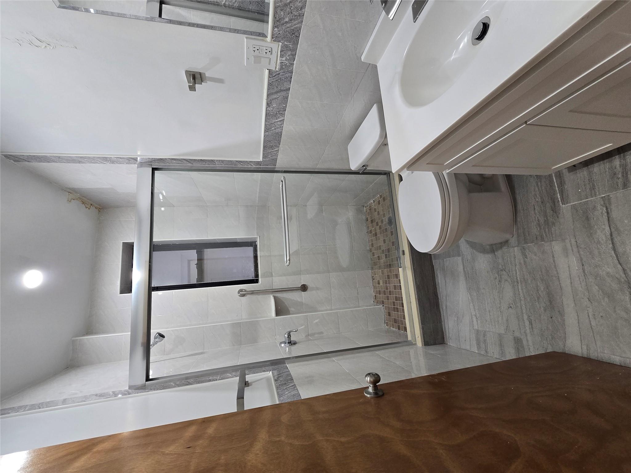 618 Riverside Drive, Unit 24 Manhattan, NY 10031 - Photo 16 of 16 Bathroom featuring vanity, a stall shower, tile walls, and toilet