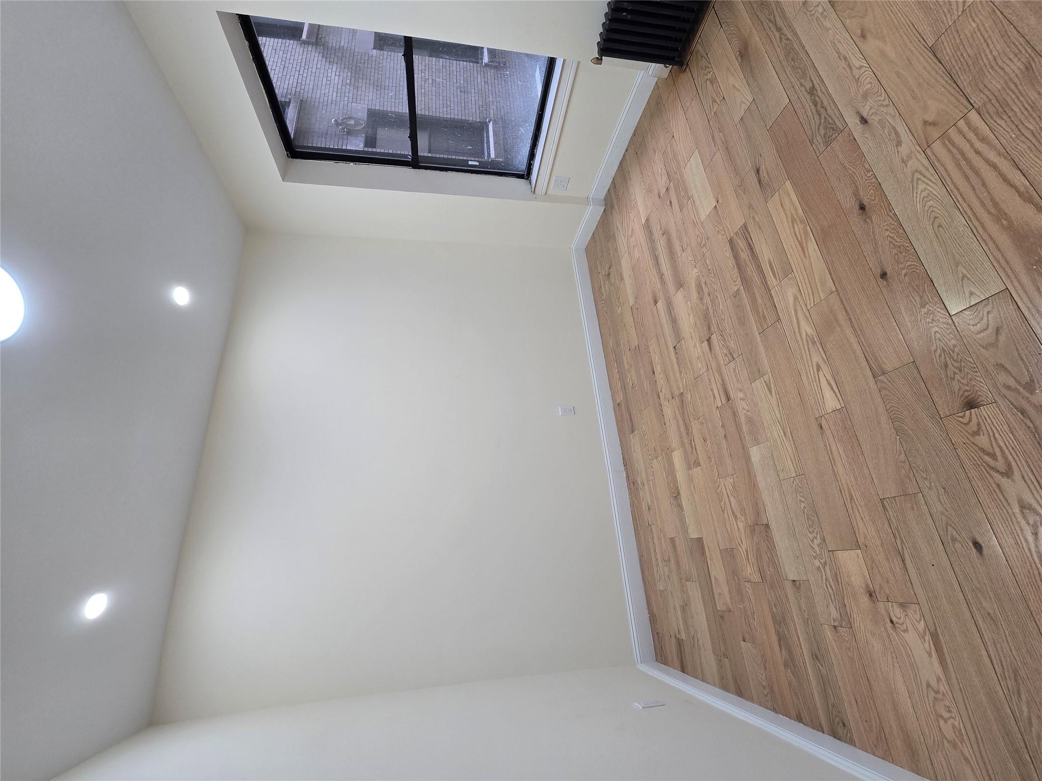 618 Riverside Drive, Unit 24 Manhattan, NY 10031 - Photo 6 of 16 Unfurnished room featuring baseboards, light wood-type flooring, radiator, and recessed lighting