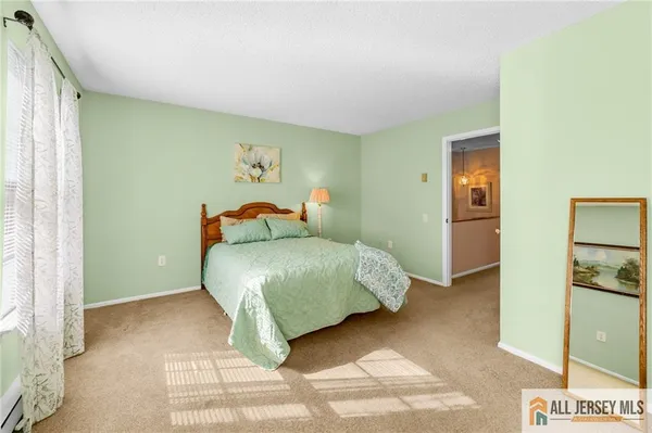 a bedroom with a bed and a painting on the wall