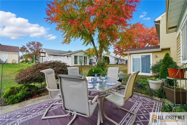 a view of a house with backyard sitting area and garden