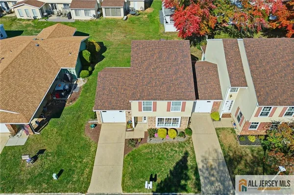 an aerial view of multiple houses with yard