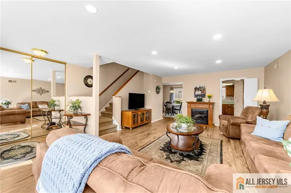 a living room with furniture a fireplace and a table