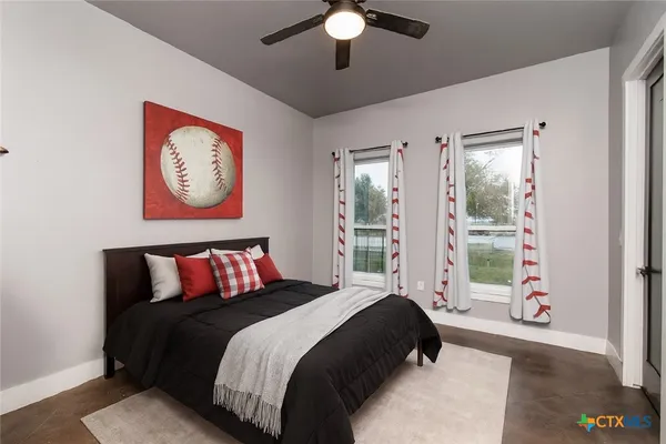 a bedroom with a bed and a chandelier