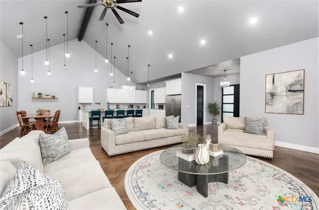 a living room with furniture kitchen and a table