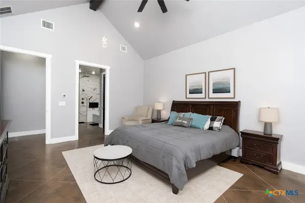 a bedroom with a bed and a chandelier