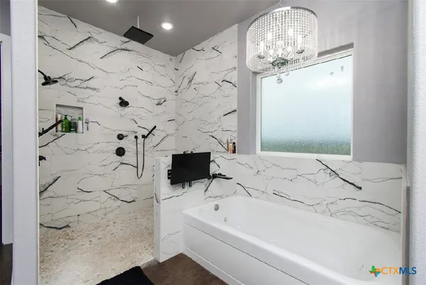 a bathroom with a bathtub and shower