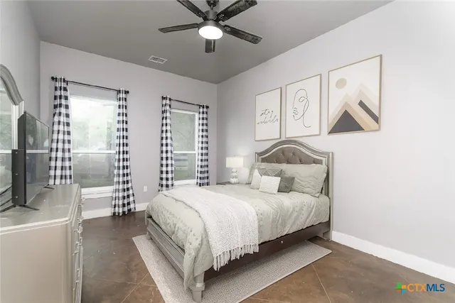 a bedroom with a bed and a potted plant