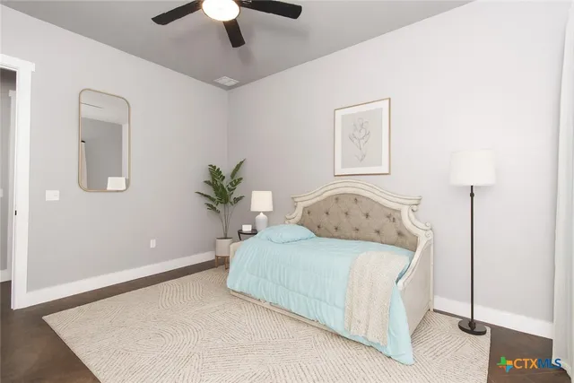 a bedroom with a bed and a dresser