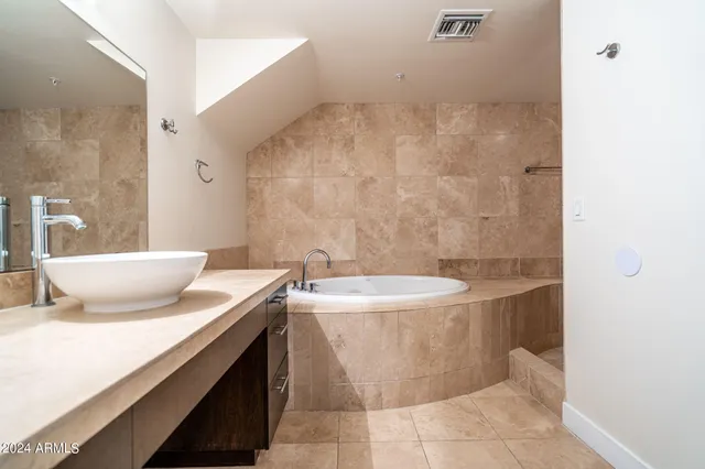 a bath room with a sink and a mirror