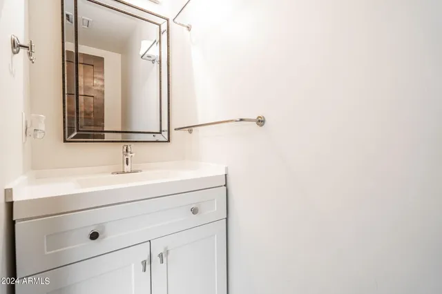 a bathroom with a sink and a mirror