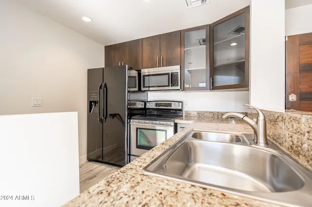 a kitchen with a sink and a refrigerator