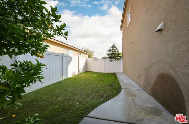 an aerial view of a house with swimming pool and large trees