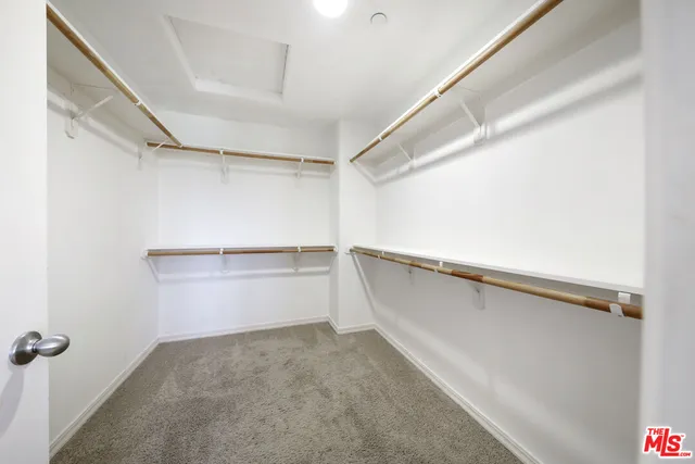 a bathroom with a granite countertop sink a large mirror and a bathtub